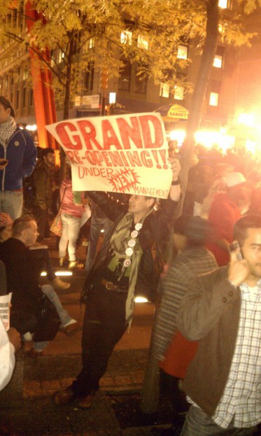 Protester proclaims the grand re-opening of Zuccotti Park, Tuesday, Nov. 15.