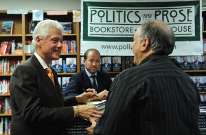 Former US president Bill Clinton signs a