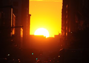 The sun sets along 34th Street, aligning