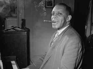 Those were the days: Pianist Willie "the Lion" Smith smoking in his NYC apartment in 1947.