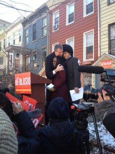 Bill de Blasio hugging his wife and son outside his home today. 