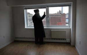 Rabbi David Niederman looks out of the window of the Schaefer Building.