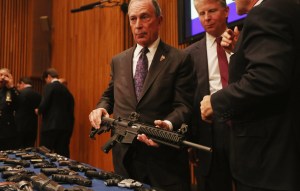 Mayor Michael Bloomberg holding an AR-15 assault rifle like the one used in the Newtown shootings at a press conference announcing a gun trafficking bust last October. (Photo: Getty) 