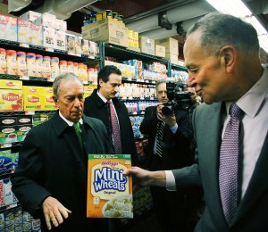 Senator Schumer attempts to hand some cereal to Mayor Bloomberg. (Photo: Getty)