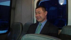 John Liu riding in the back of the press van, chatting with reporters.