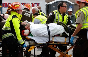 BOSTON, MA - APRIL 15: A man is loaded into an ambulance after he was injured by one of two bombs exploded during the 117th Boston Marathon near Copley Square on April 15, 2013 in Boston, Massachusetts. (Photo by Jim Rogash/Getty Images)