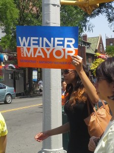 A member of the Weiner campaign holds up a sign on Austin Street.