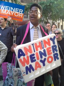 A sign-wielding Anthony Weiner volunteer outside a Hunter College debate yesterday.