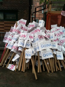 The discarded signs from Quinn's camp. 