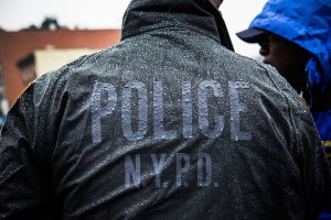 A police officer observes an anti-stop-and-frisk rally in February. (Photo: Getty)