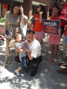 Mr. Liu tickles a young supporter.