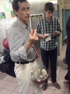 Anthony Weiner waits, with his cupcakes, for an elevator ride.