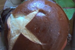 The pretzel bacon cheeseburger, as seen from above. (Screencap: YouTube)