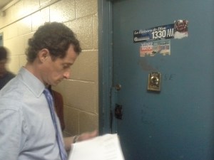 Mr. Weiner waits for a voter with a Weiner campaign sticker on his door.