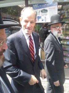Mr. Spitzer walks Boro Park with Orthodox Jewish leaders.