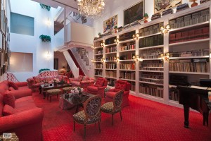 The double-height living room with bookshelves illuminated for better browsing.