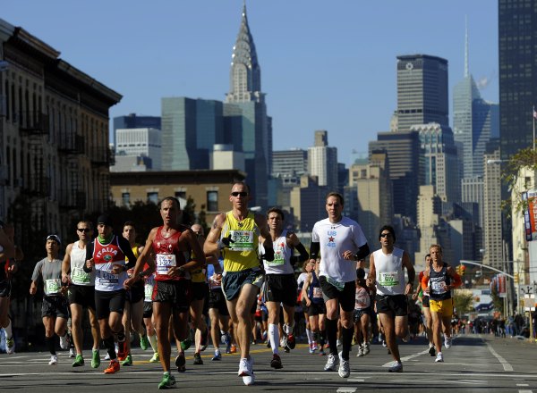 Runners make their way through Queens. (Photo by TIMOTHY A. CLARY/AFP/Getty Images)