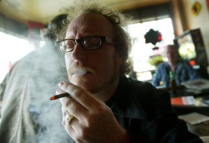 Man smokes in bar. (Photo by Mario Tama/Getty Images)