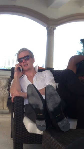 Still on the phone, feet up.