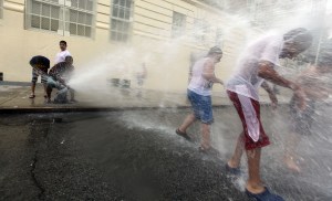 Bronx children cool off during the 2011 heat wave. (Photo: Mario Tama/Getty)