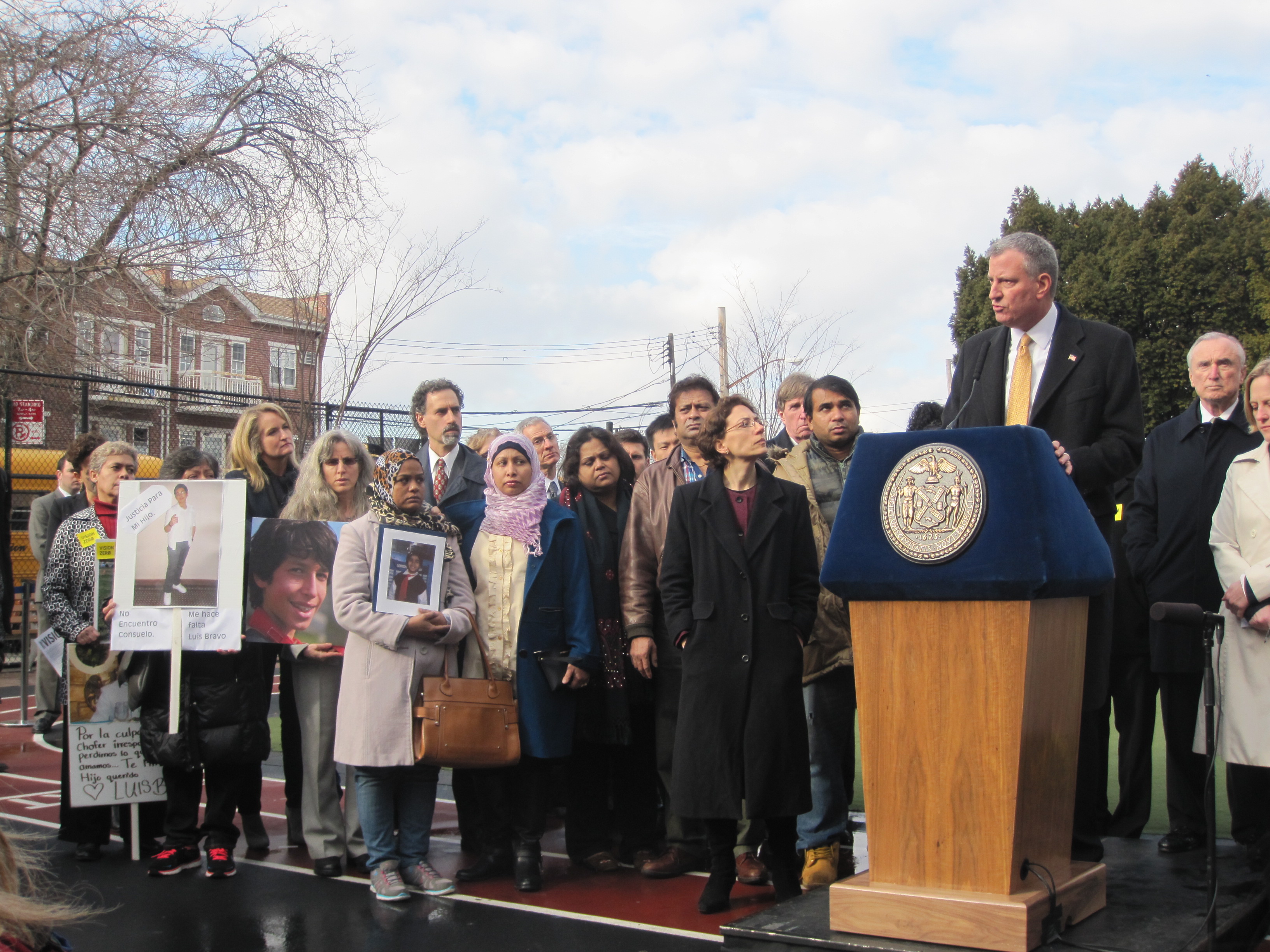 Bill de Blasio standing with parents this afternoon.