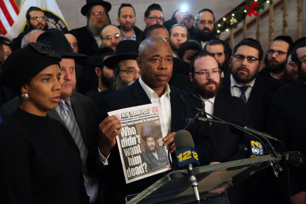 Brooklyn Borough President Eric Adams  holds up a copy of the New York Post at today's protest. (Photo: Kathryn Kirk)