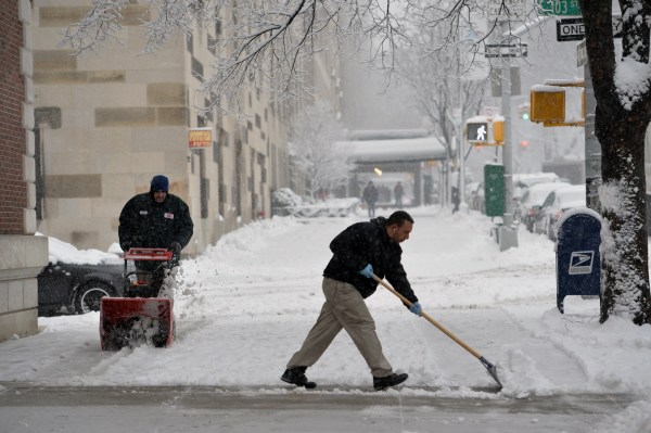 Harlem residents clear snow for the umpteenth time this week. STAN HONDA/AFP/Getty Images