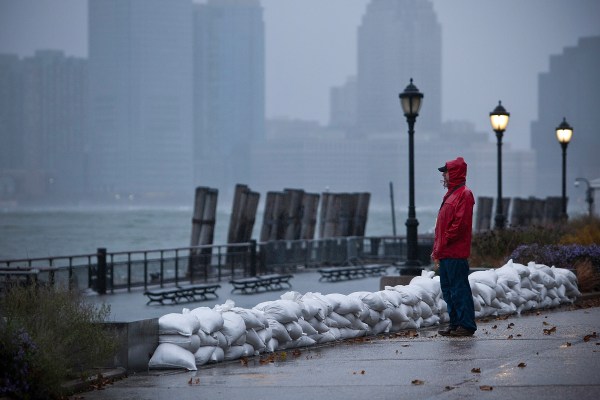 A man watches the waves in New York Harbor from Battery Park during the arrival of Hurricane Sandy. (Photo via Getty Images)
