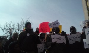 Protesters wave signs like "Astori-NO!" behind Mr. Astorino as he speaks.