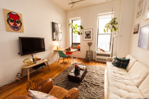 The living room, featuring a portrait by Craig Redman. (Photo by Emily Assiran)