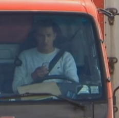A truck driver using his phone. (Screengrab via ABC News)