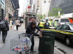 A canner collecting recyclables from a garbage can in NYC. (essygie/Flickr)