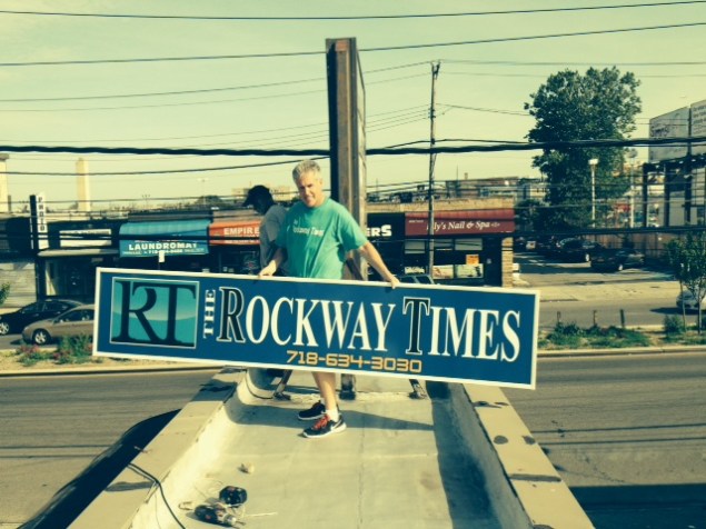 Kevin Boyle, owner and editor of the Rockaway Times, gets ready to publish his first issue next week, putting the sign up in front of his bare bones office. (Courtesy of Kevin Boyle)