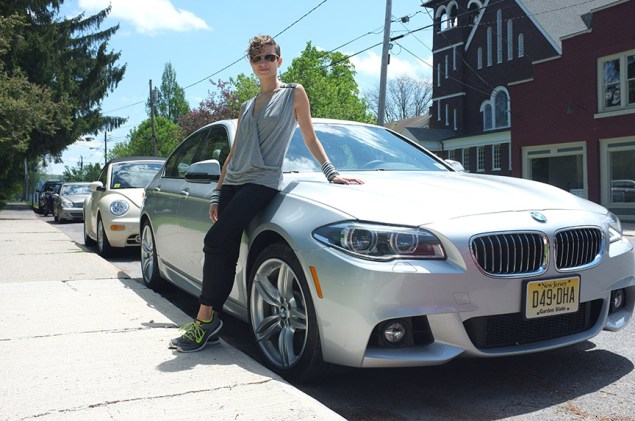 The author's travel companion poses with an automobile.