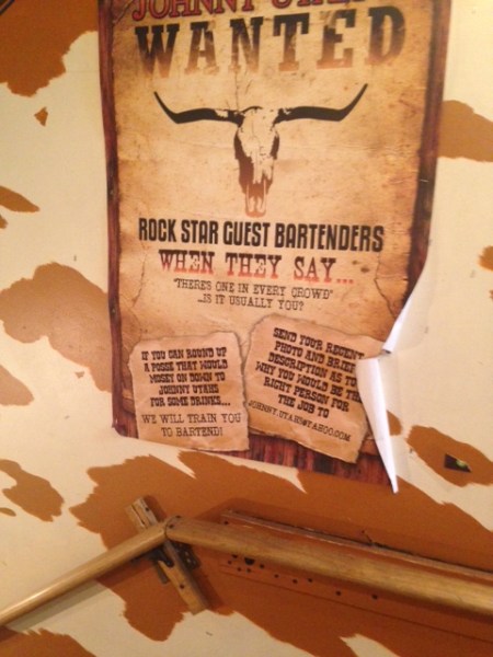 This help wanted posted decorates the stairway into the cellar that is Johnny Utah's. (Photo: Alexandra Sternlicht)