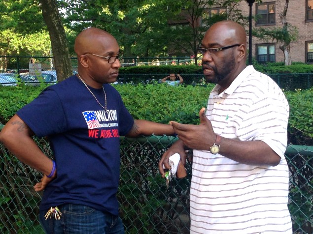 Pastor Mike Walrond listens to a potential voter on 108th Street and First Avenue. 