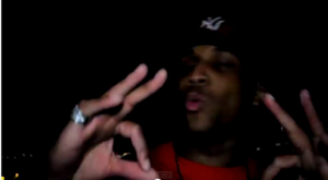 Ronald "Ra Diggs" Herron throws up what is known to be a gang sign in his video for "Live by the Gun, Die by the Gun."