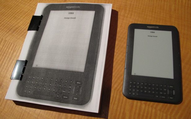 On the right is a Kindle displaying a book. On the left is a book displaying that Kindle displaying a book. (Photo via Jesse England)