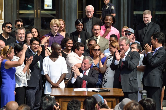 The mayor signs municipal identification legislation in Brooklyn, a day after holding a City Hall hearing. (Rob Bennett/Mayor's Office)