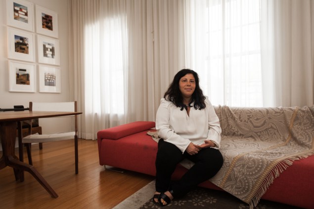 Alice Roi, at home. In the far corner is a series of Edward Ruscha prints. (Photo by Emily Assiran)