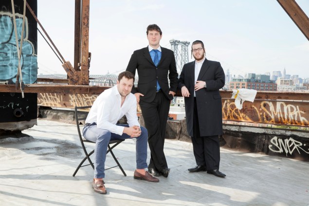 EXR founders Mario Faggiano, John Le Vine and Sam Rubin atop a building in Williamsburg. (EXR Group) 