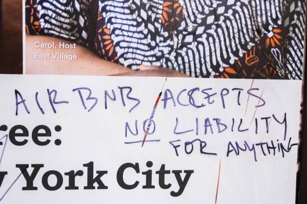 The ads paint a rosy pictures of New York's relationship with Airbnb. Some New Yorkers have taken that branding effort into their own hands on the ads at 14th Street Station. (Photo by Daniel Cole)