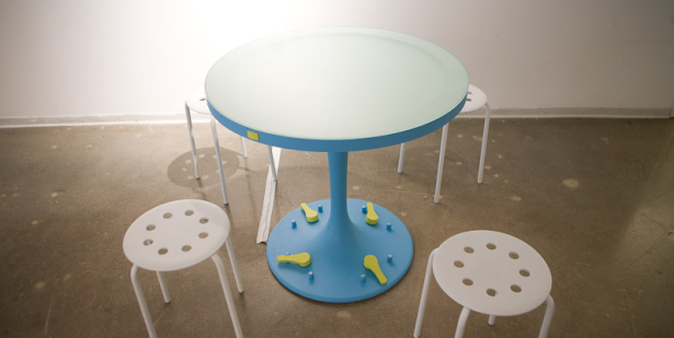 Ms. McCarthy's "Relatable" is a table that has footpedels so that you can indicate your declining interest in someone's small-talk. The table will flash a distress beacon if the conversation becomes too intolerable. (Photo via Lauren McCarthy)