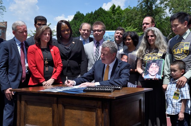 Mayor Bill de Blasio signs Vision Zero legislation in Queens last month.  (Diana Robinson/Mayor's Office)