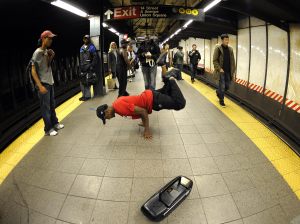 A subway performer dancing on a platform. (Getty)