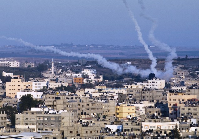 Smoke trails mark the path of Palestinian missiles fired from Gaza City. (Photo by ROBERTO SCHMIDT/AFP/Getty Images)