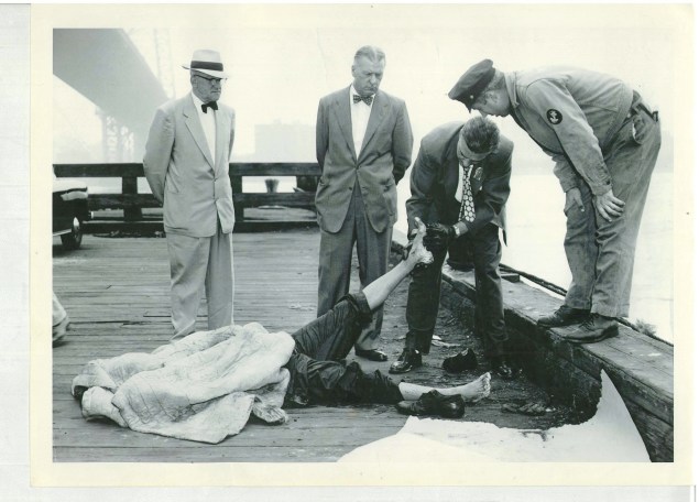 Commissioner Kennedy and Inspector Thomas Nielson watch detectives examine the body of Willie Menter