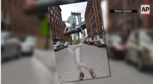 After Trina Merry paints her models, she photographs them against NYC backdrops. (AP/YouTube)