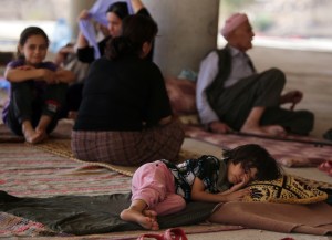 A child sleeps as Iraqi Yazidis take refuge in Dohuk. (Photo by Ahmad Al-Rubaye/AFP/Getty Images)