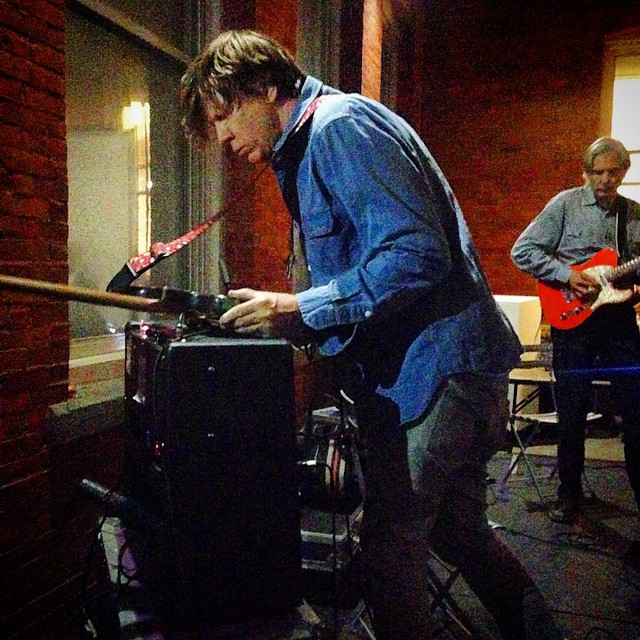 Thurston Moore performs with James Nares just outside the entrance of MoMA PS1. (Photo courtesy @lolitaphon on Instagram) 